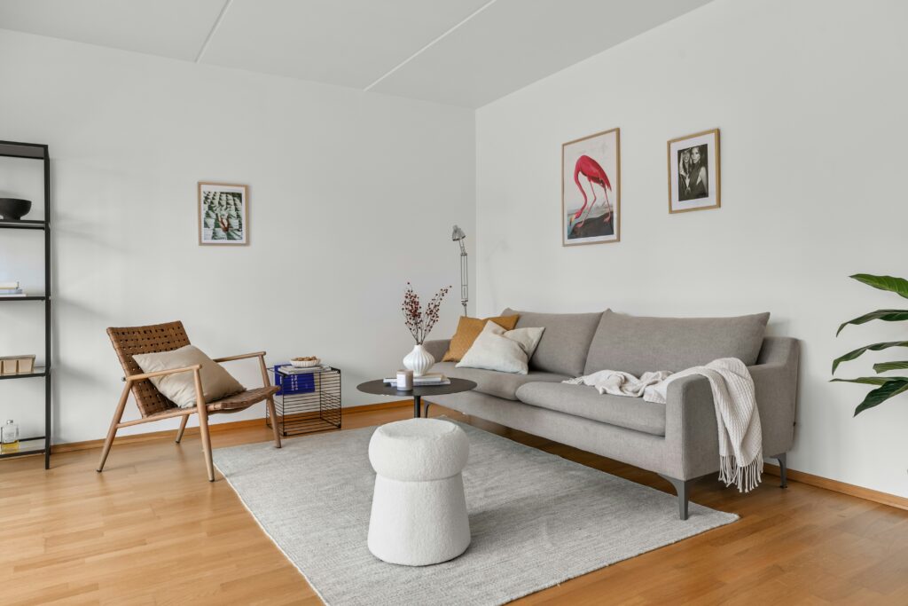 Minimalist living room with neutral sofa and white textured stool